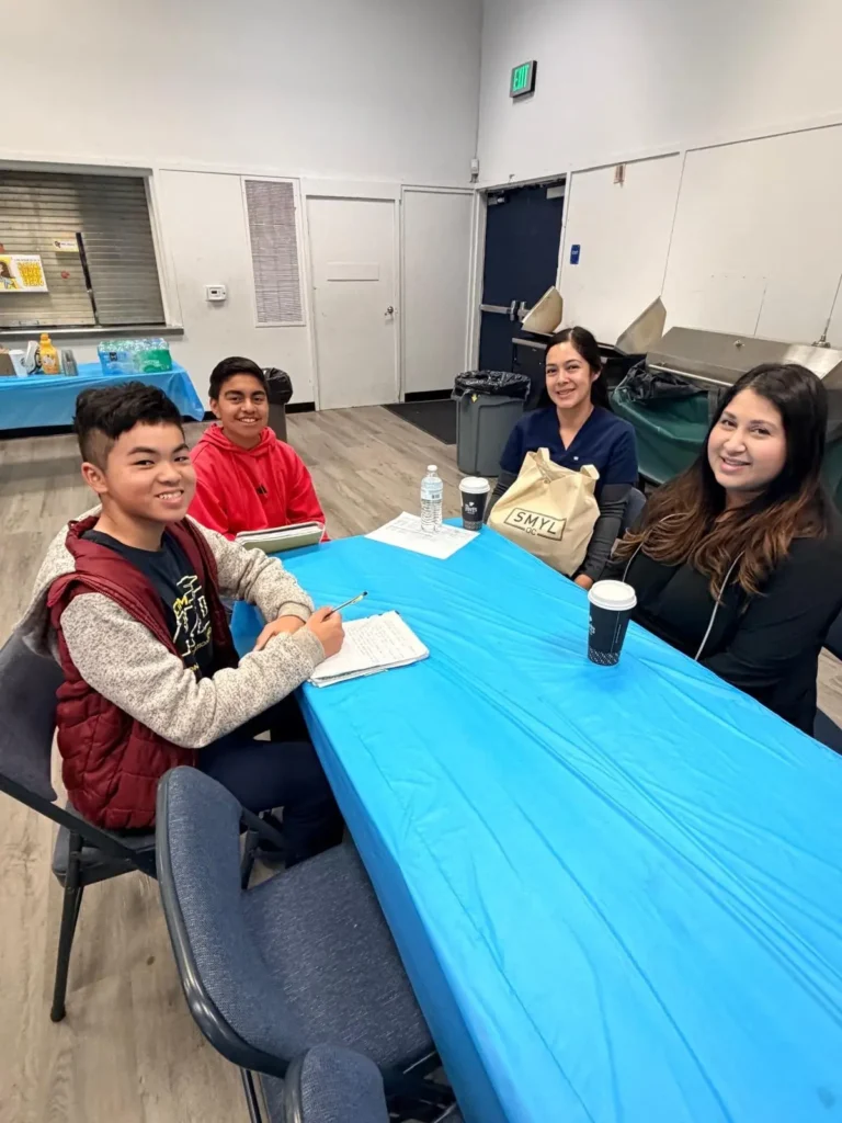 Smyl OC Dentistry team sitting with AVID students at Columbus Tustin Middle School Career Day
